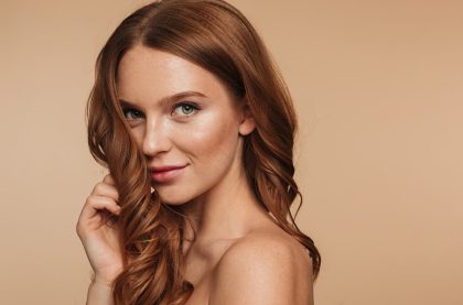 beauty-portrait-mystery-smiling-ginger-woman-with-long-hair-posing-sideways-looking-min